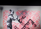 20211116-IMG 2763  Banksy - Petite fille recouvrant une croix gammée - Paris - France - 2018 - The Word of Banksy -  Paris 9eme - France - le 16/11/2021 : PARIS, STREET ART, STREET ART-BANKSY